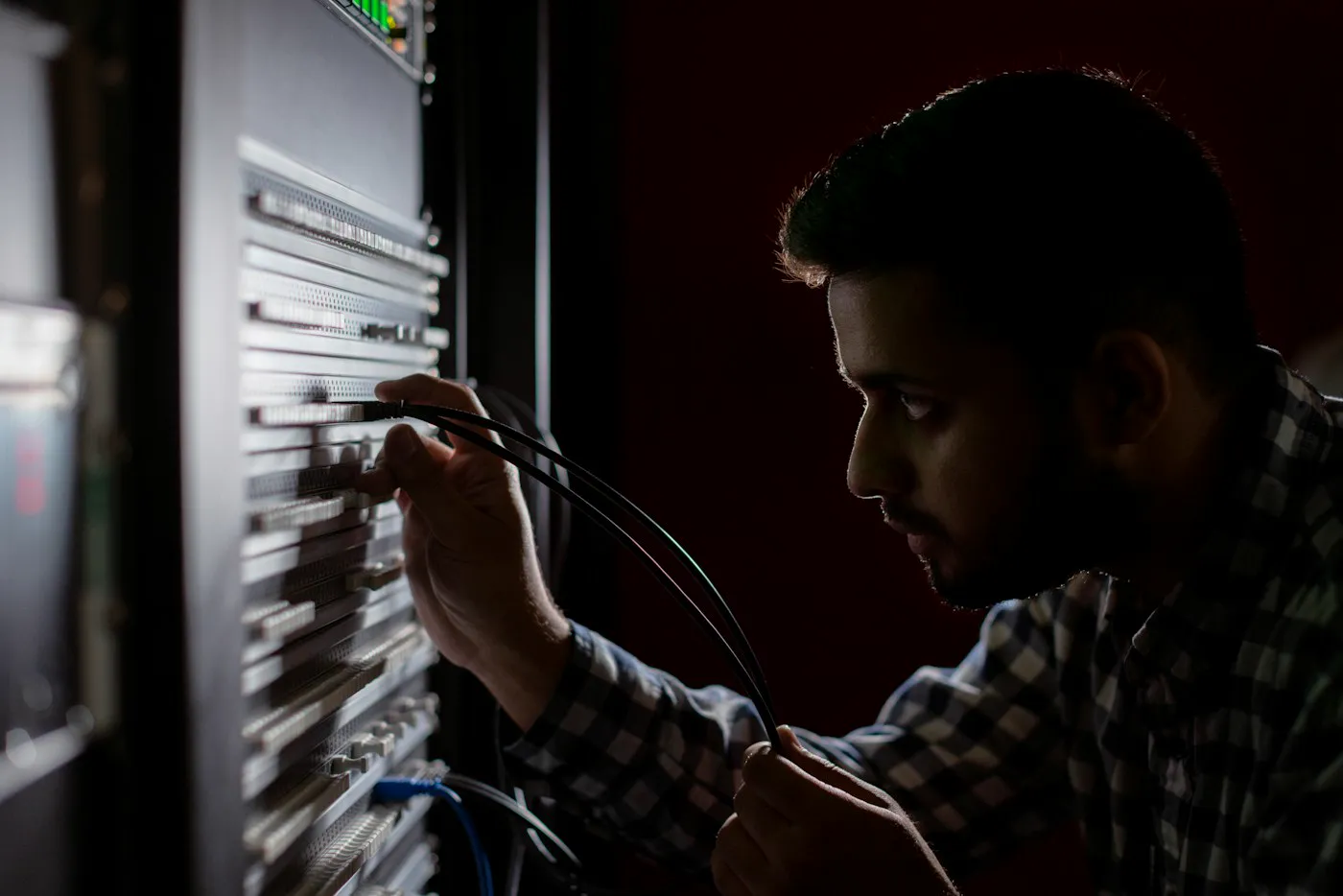 BluDATA engineer working on network cabling